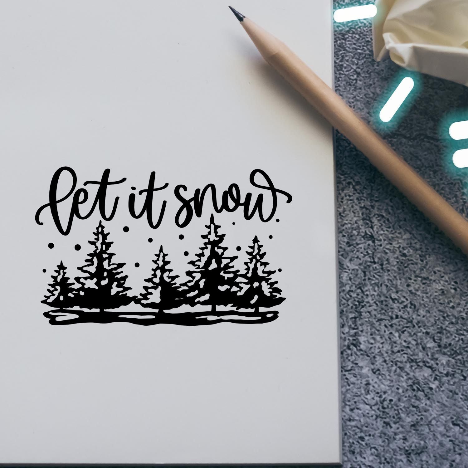 Let it snow pine tree rubber stamp on paper for winter holiday cards and handmade crafts.
