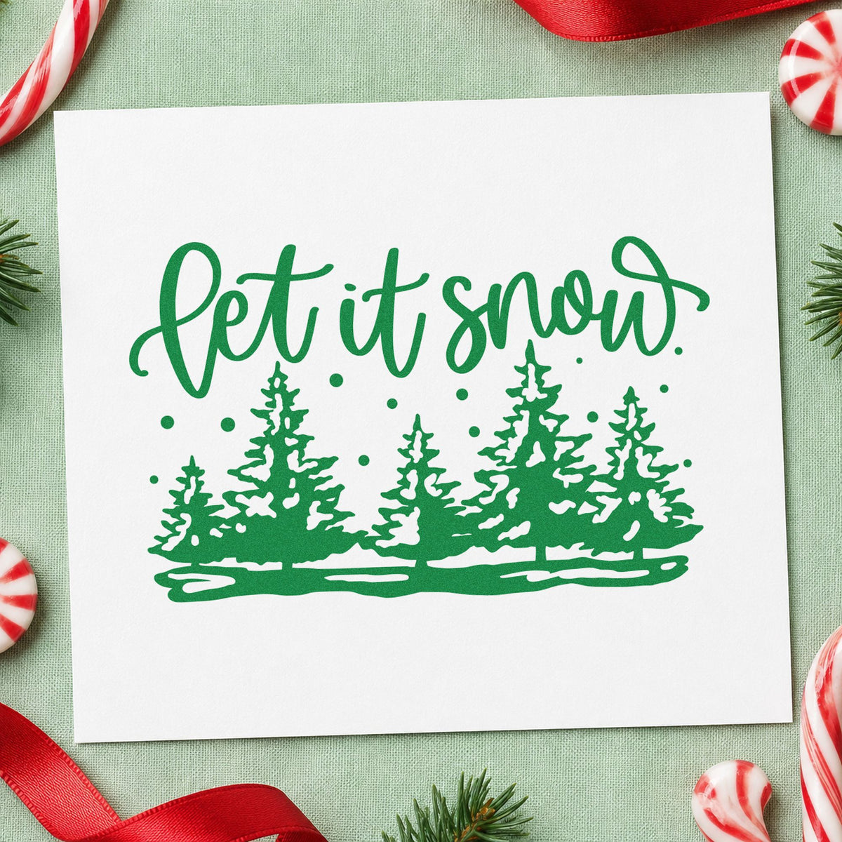 Let It Snow Pine Forest craft stamp imprint in green ink on a handmade project, one idea being sapling gift tags.