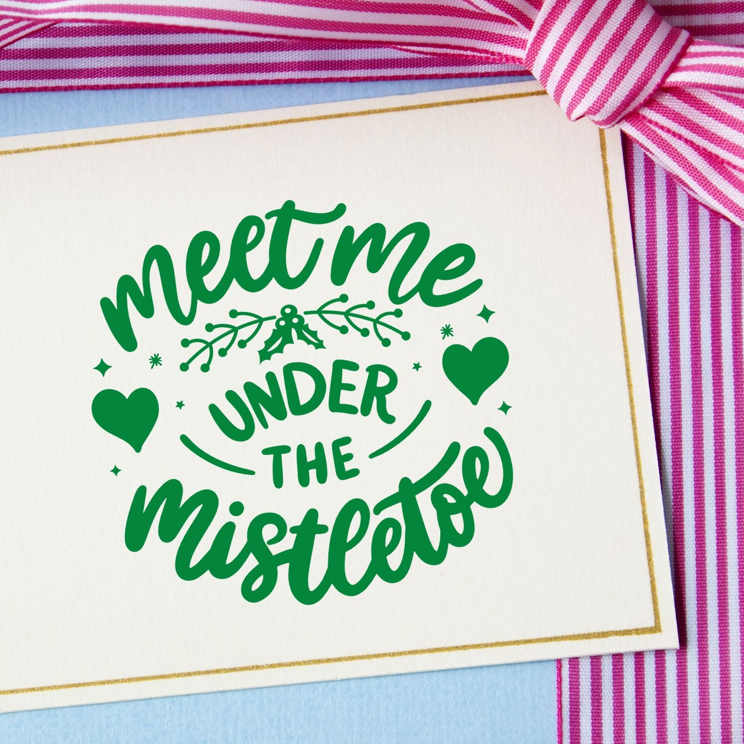 Christmas rubber stamp design reading "Meet Me Under the Mistletoe" with hearts and mistletoe for holiday cards.