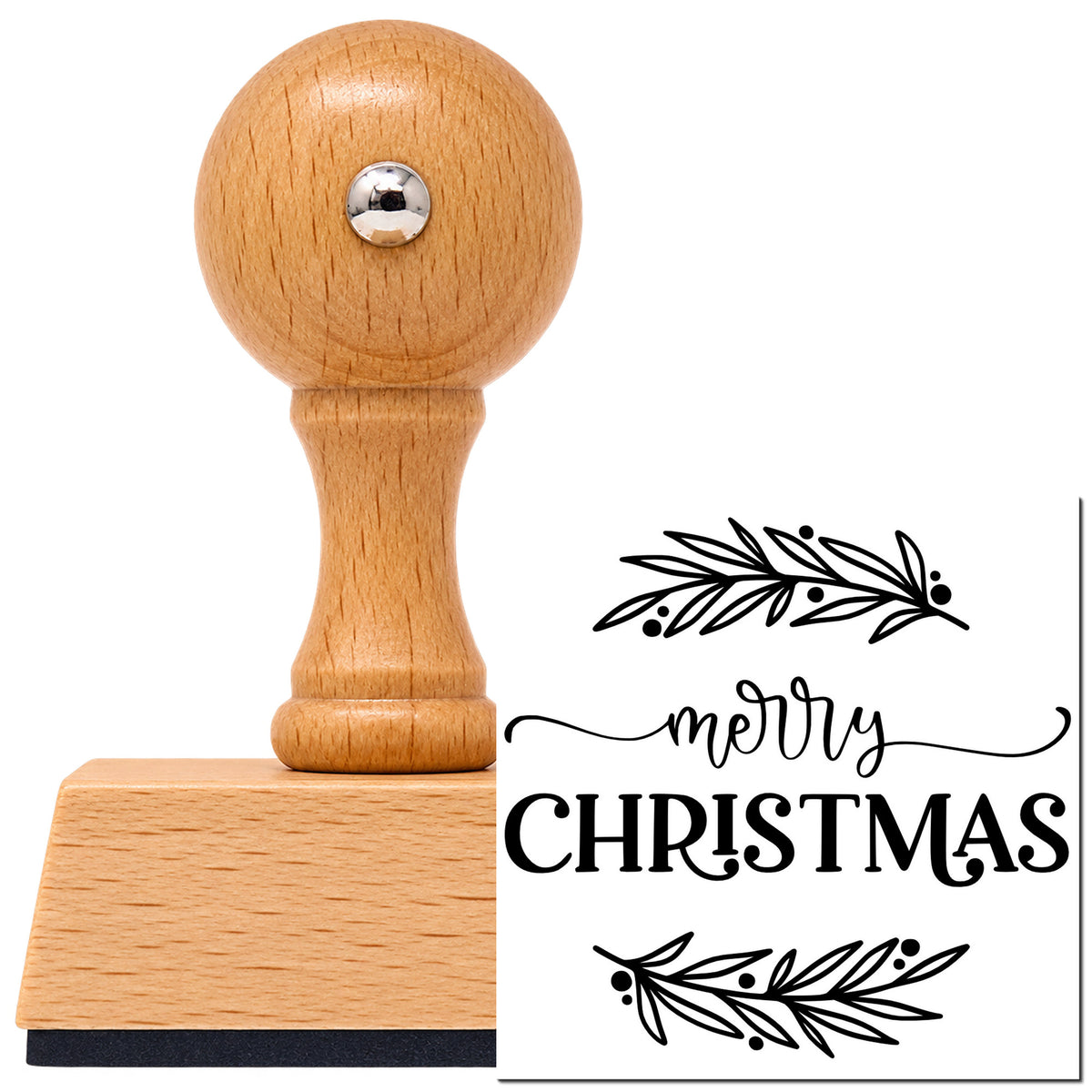 Merry Christmas Between Branches Leaf Accents Vintage Pro rubber stamp in European beech wood with a round knob handle, shown beside its black imprint.