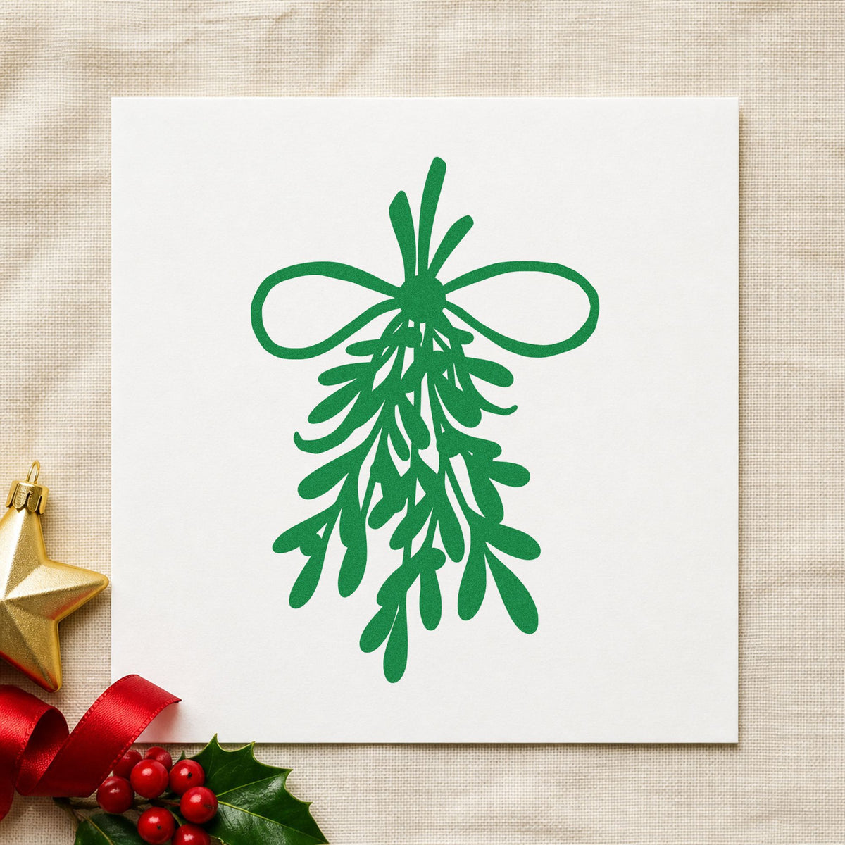 Mistletoe Bundle With Bow craft stamp imprint in green ink on a handmade project, one idea being doorway hanger cards.