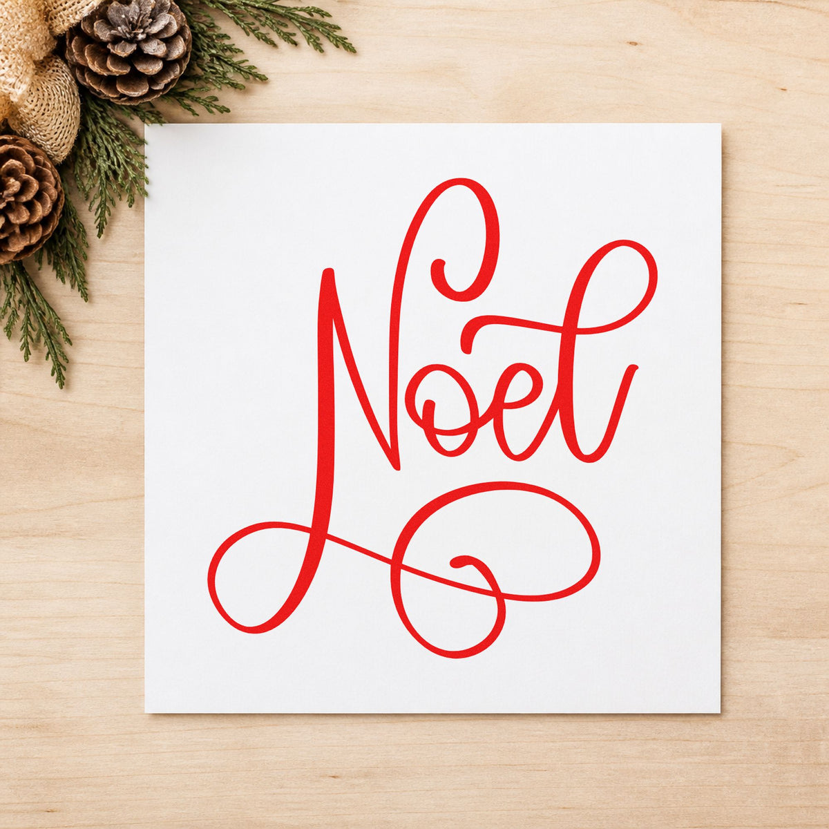 Noel Flowing Script craft stamp in red ink on cardstock, an easy option for linen pillow printing.