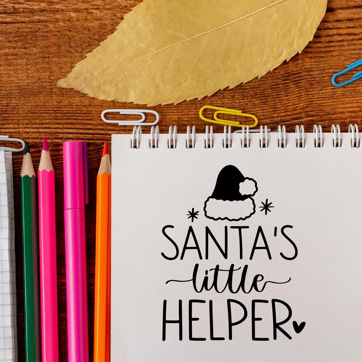 Santa's Little Helper Hat With Stars Stamp - Premium Vintage Pro Wooden imprint stamped in blue ink. "Santa's Little Helper" appears beneath a Santa hat with stars and a small heart.