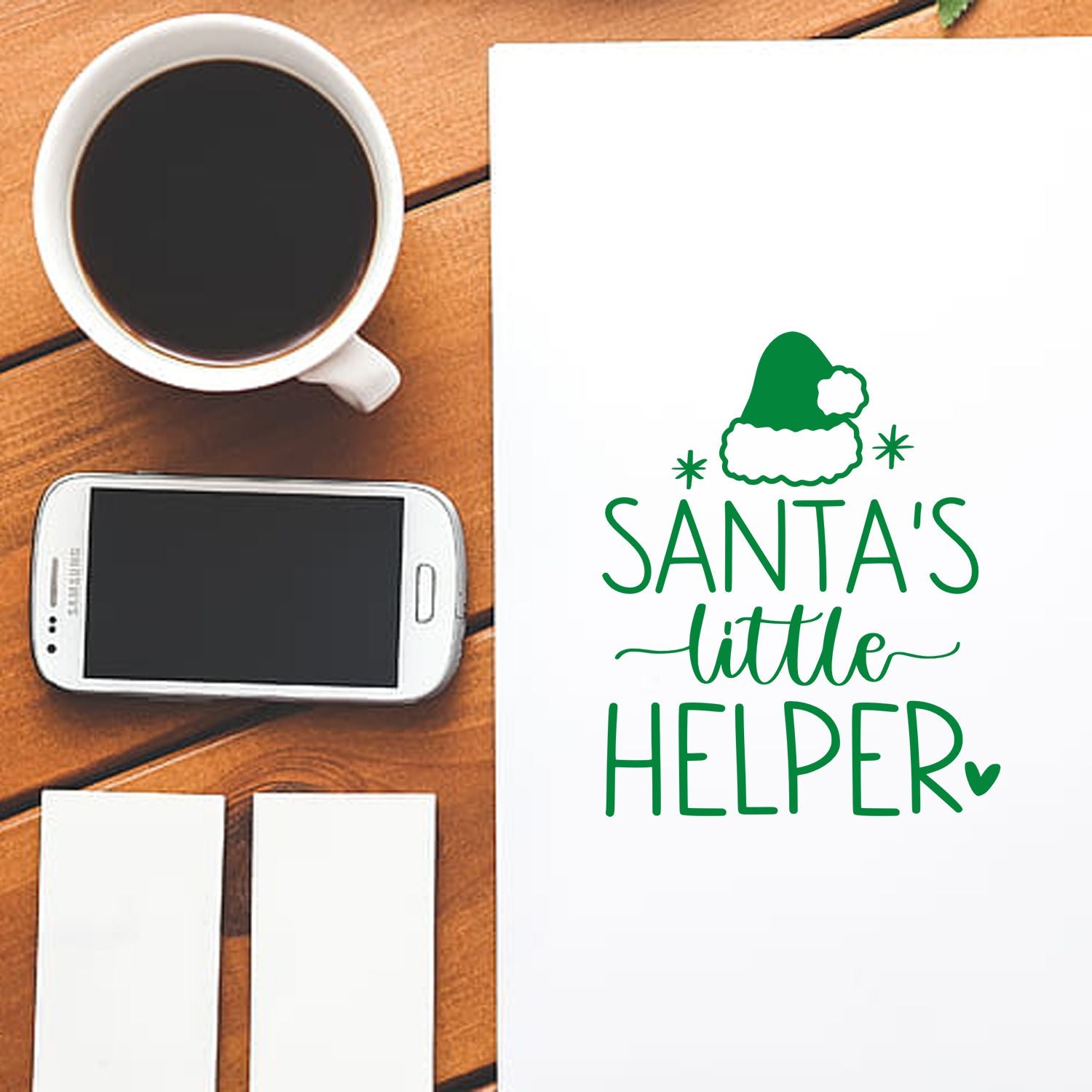 Santas Little Helper Christmas rubber stamp design on white cardstock, styled in a desktop mockup for holiday cards and crafts.