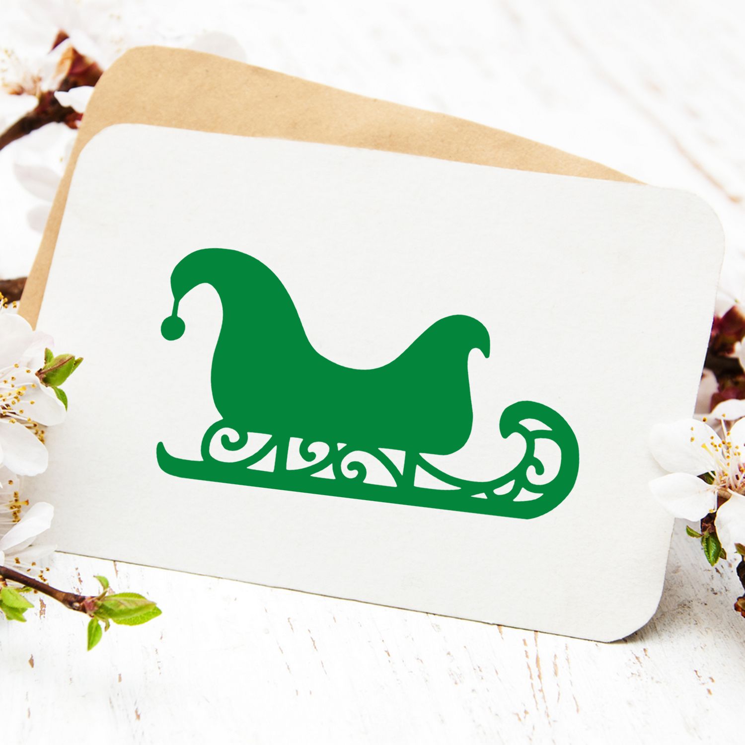 Green Santa sleigh rubber stamp design on a greeting card, ideal for Christmas crafts, holiday invitations, and scrapbooking.