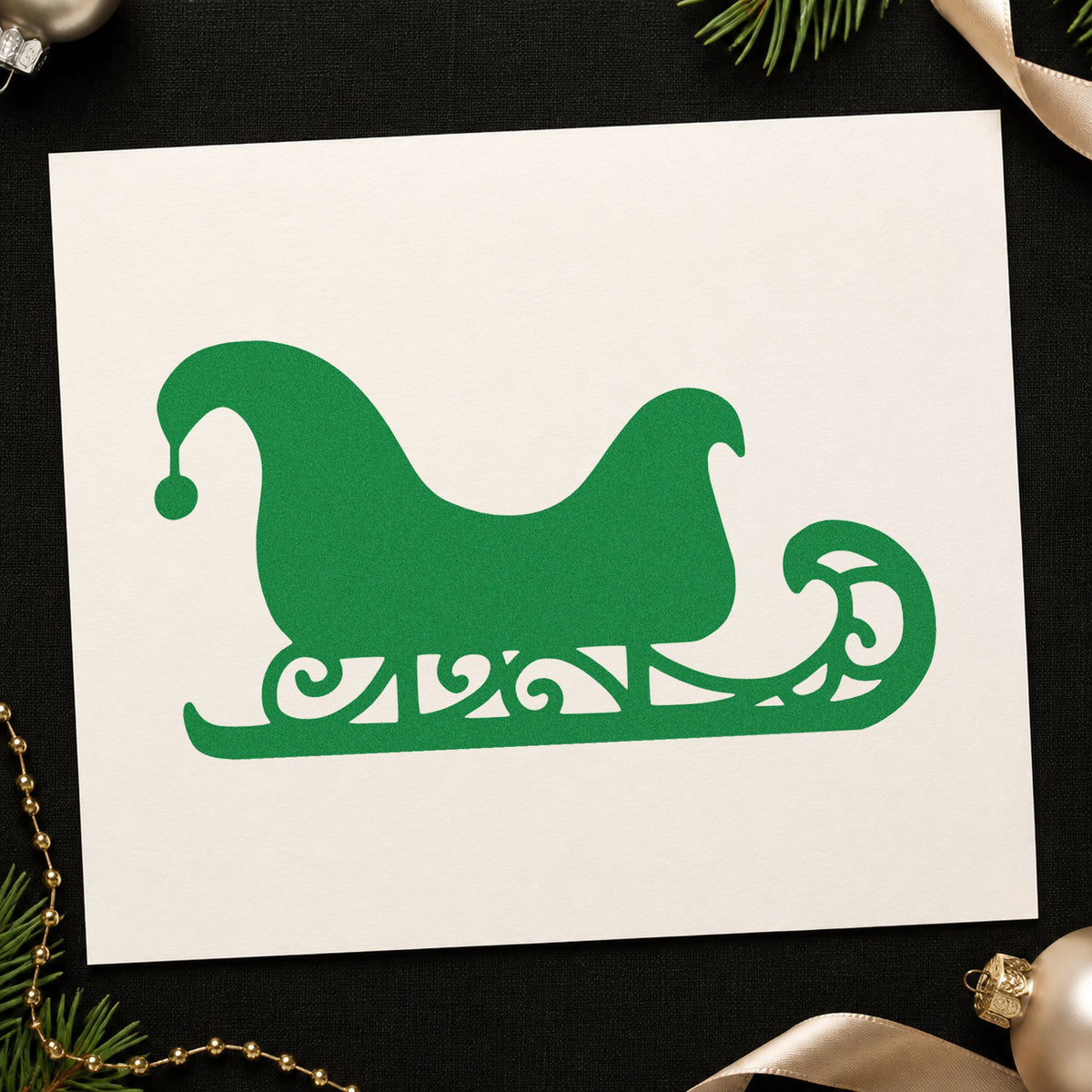 Decorative Santa Sleigh craft stamp imprint in green ink on a handmade project, one idea being ride ticket stamps.