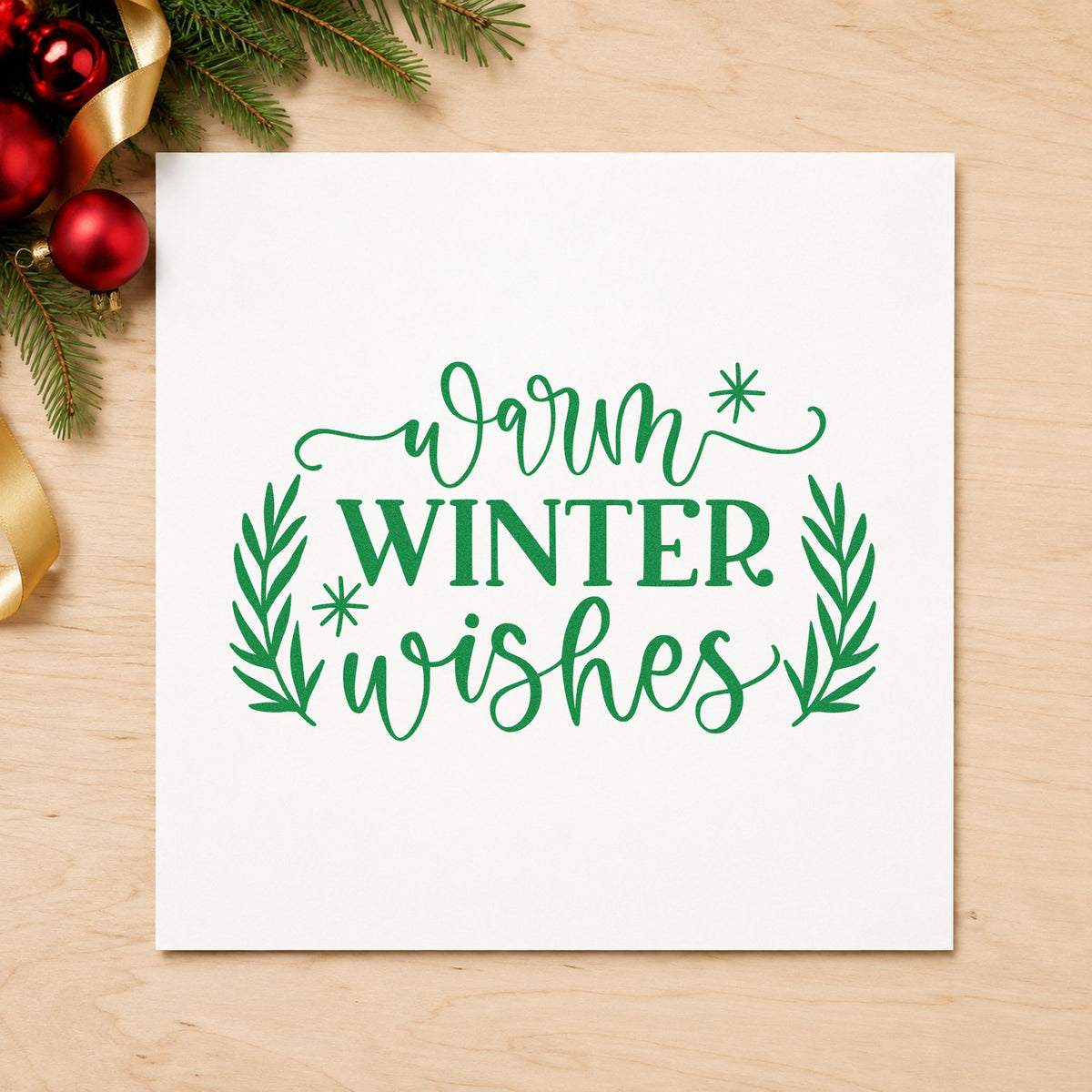 Warm Winter Wishes craft stamp imprint in green ink on a handmade project, one idea being care basket tags.