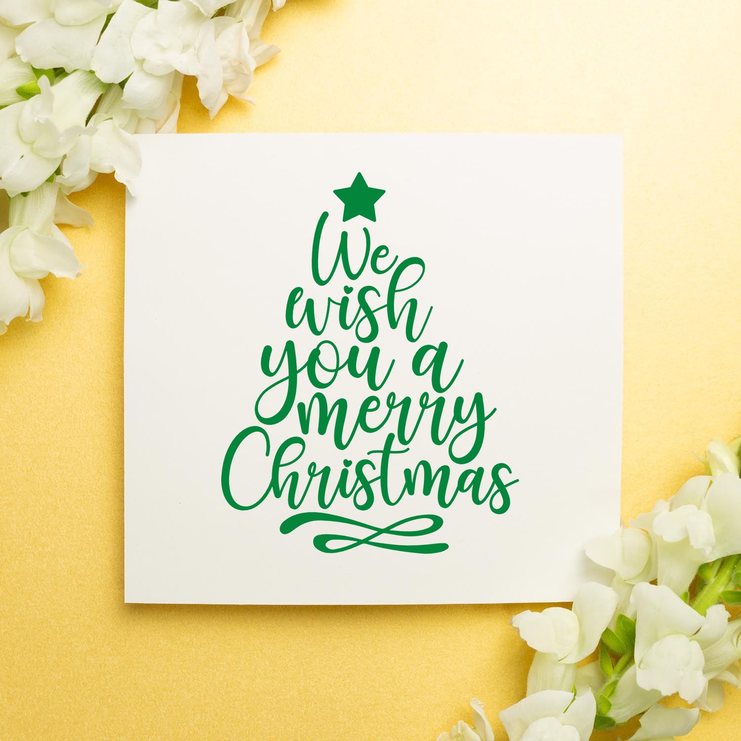 Christmas rubber stamp design with tree-shaped lettering reading We wish you a Merry Christmas for holiday cards.