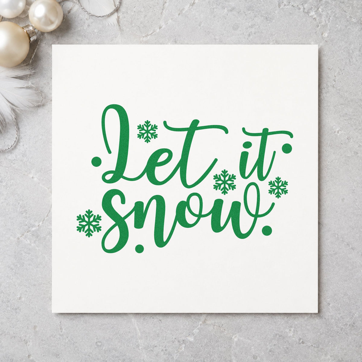 Let It Snow Snowflakes craft stamp imprint in green ink on a handmade project, one idea being hockey game passes.