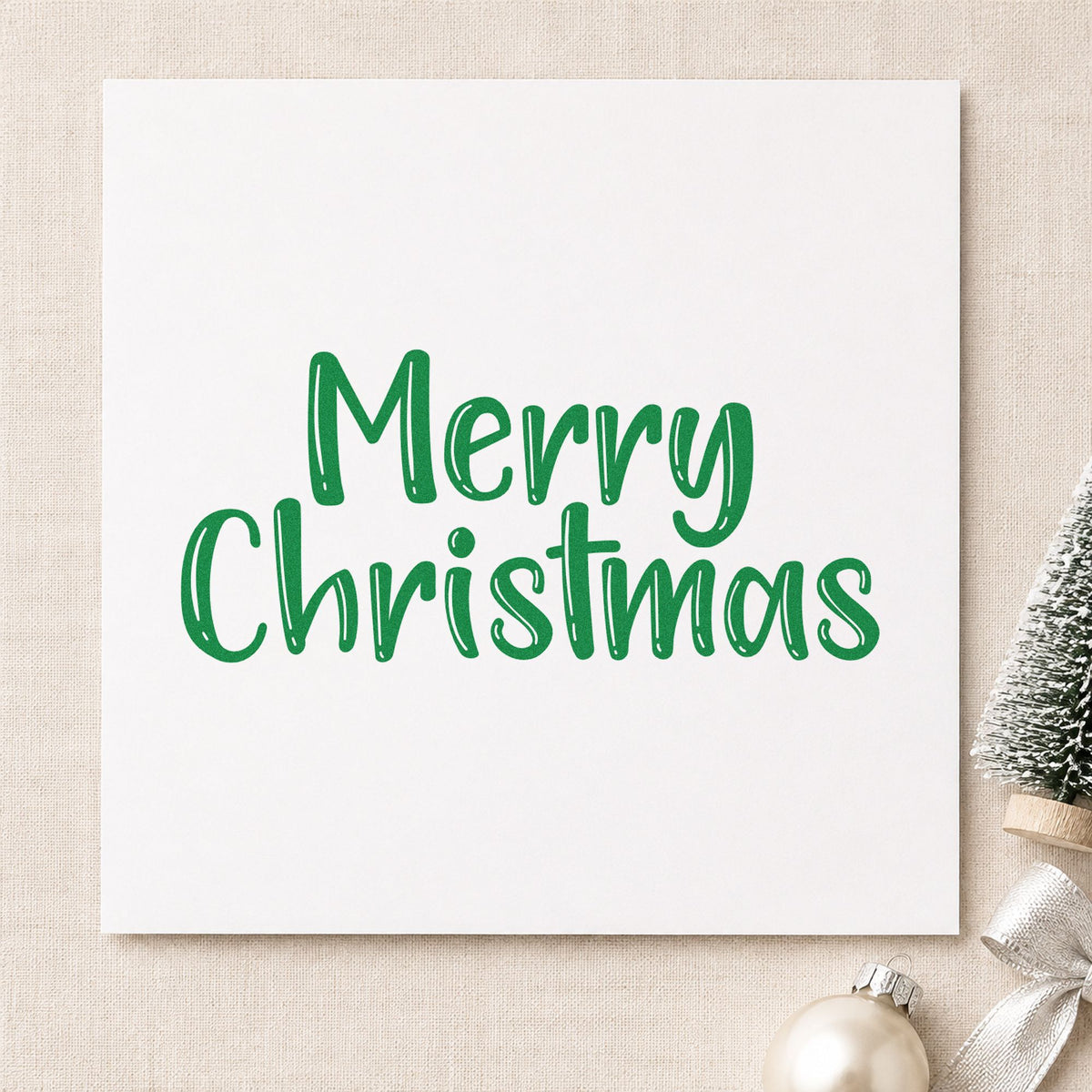 Merry Christmas Textured Letters craft stamp imprinted in green ink on paper, a design suited to framed barn wood.