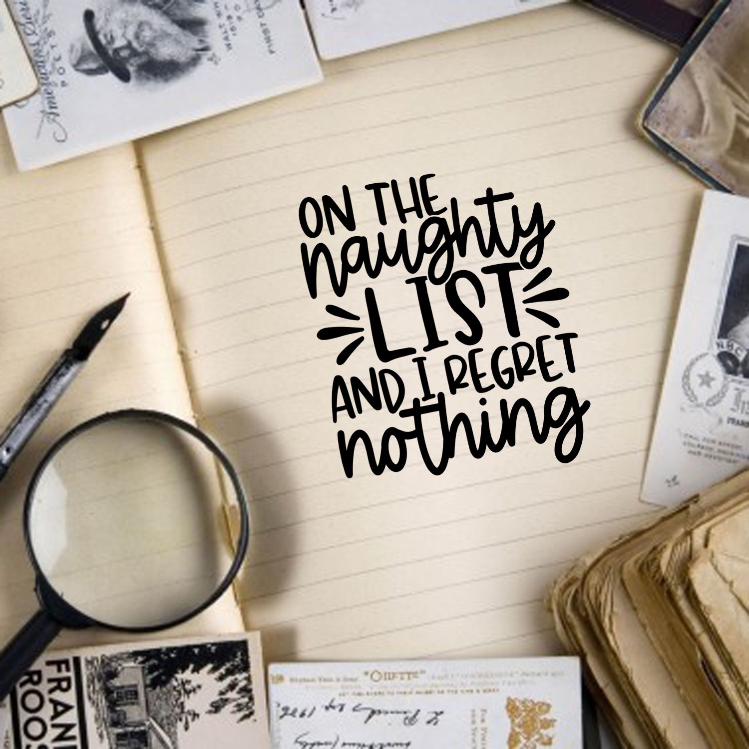 Rubber stamp-style quote on notebook page reading On the naughty list and I regret nothing, ideal for journaling and scrapbooking.
