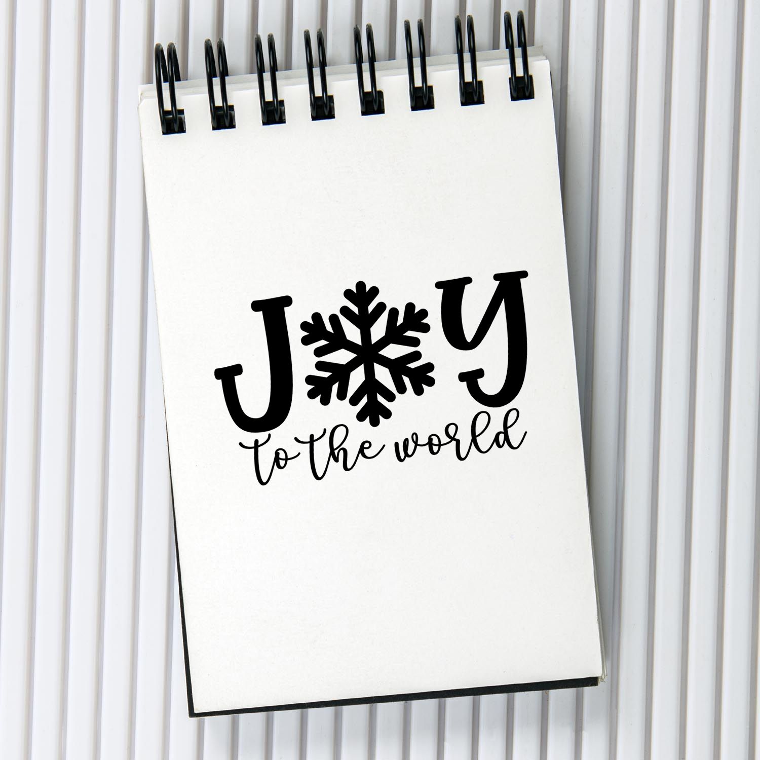 Christmas rubber stamp design with Joy to the World and snowflake, perfect for holiday cards, crafts, and scrapbooking.