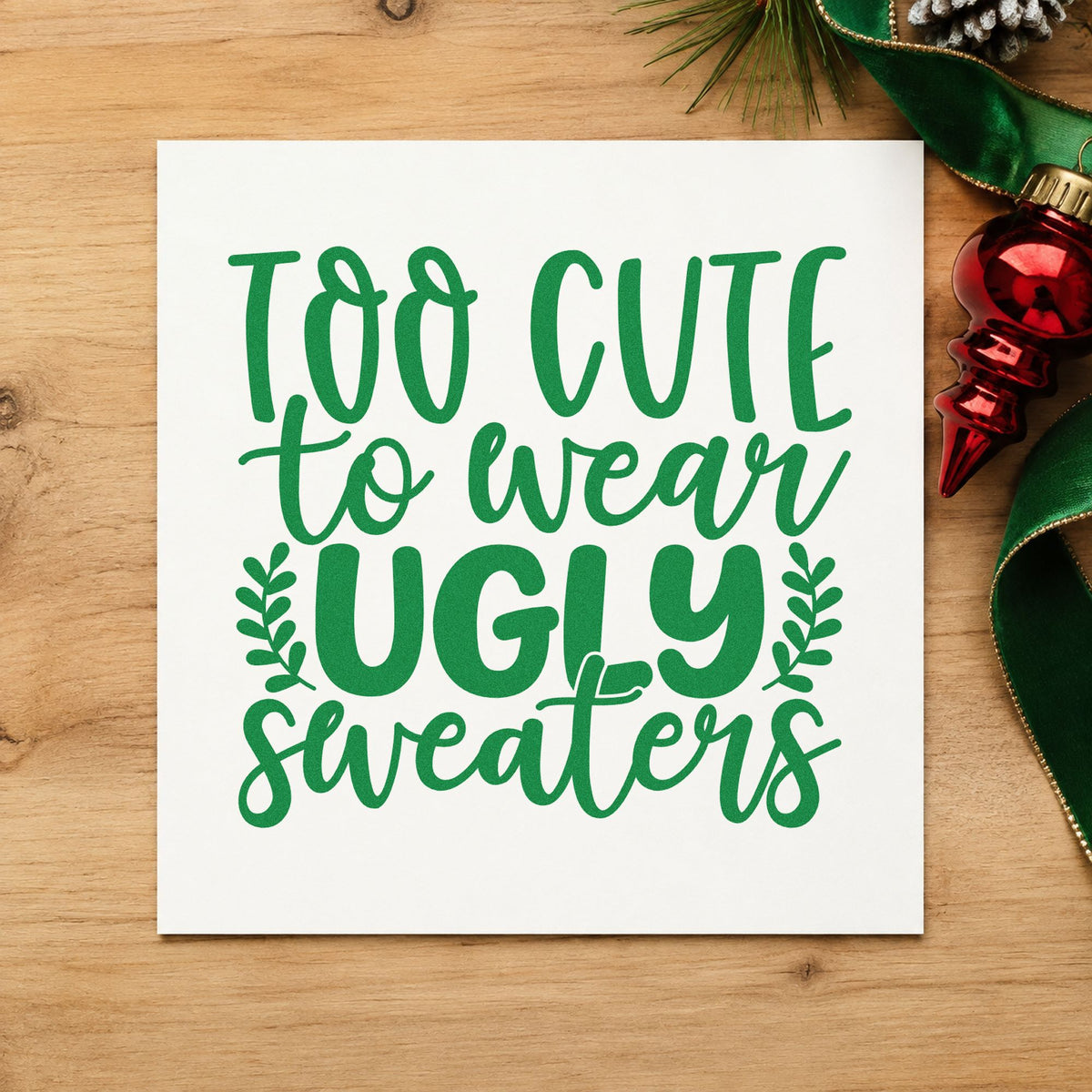 Too Cute Wear Ugly Sweaters craft stamp imprint in green ink on a handmade project, one idea being care package tags.