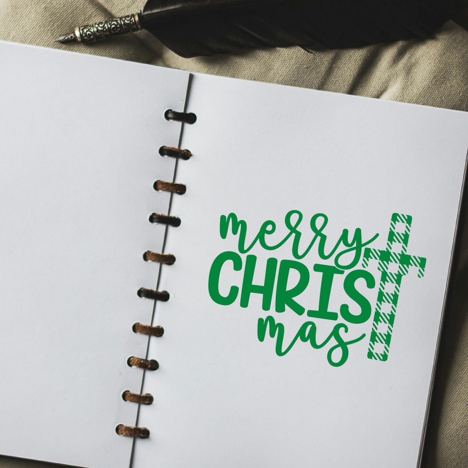 Green Merry Christmas rubber stamp design on a notebook page, perfect for holiday cards, crafts, and scrapbooking.