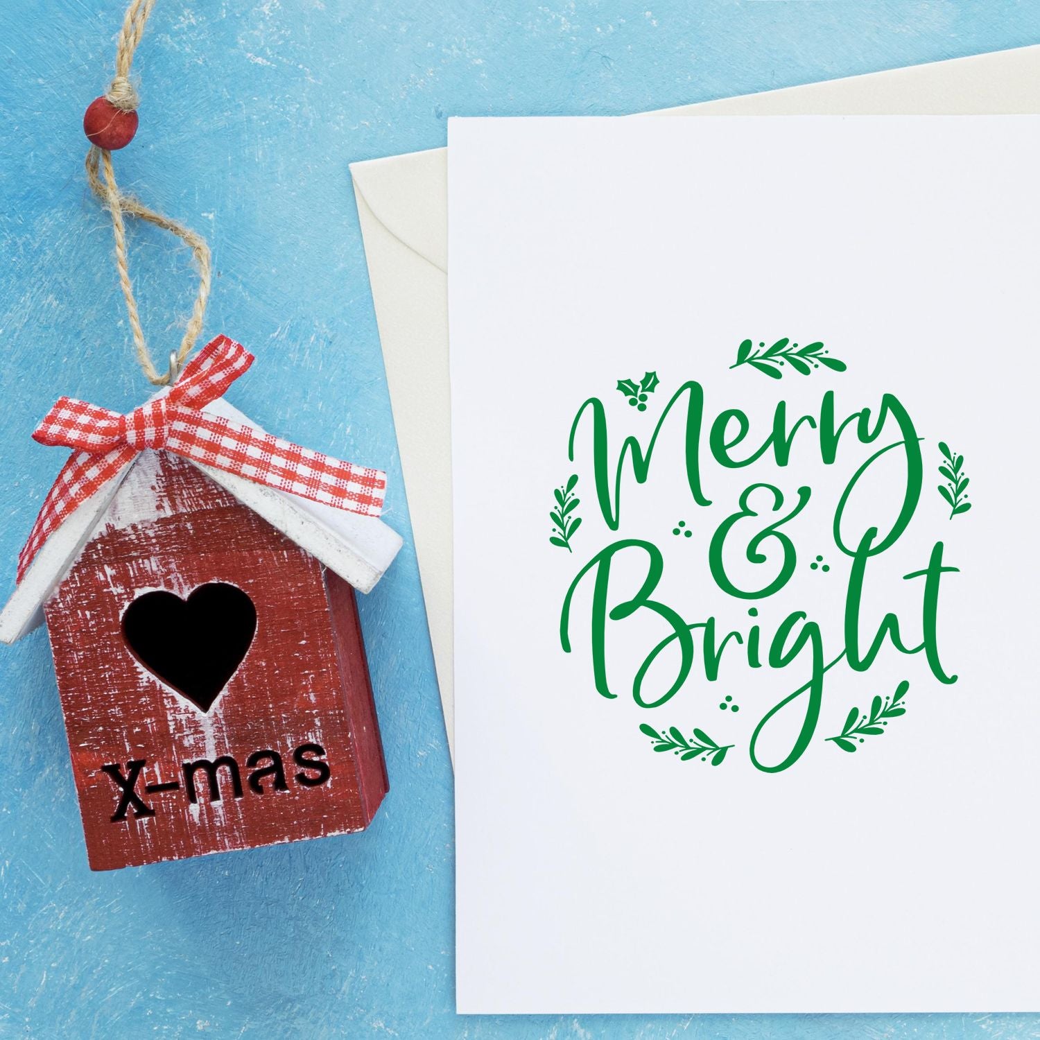 Merry & Bright Christmas rubber stamp design for handmade holiday cards, featuring festive green calligraphy and holly accents.