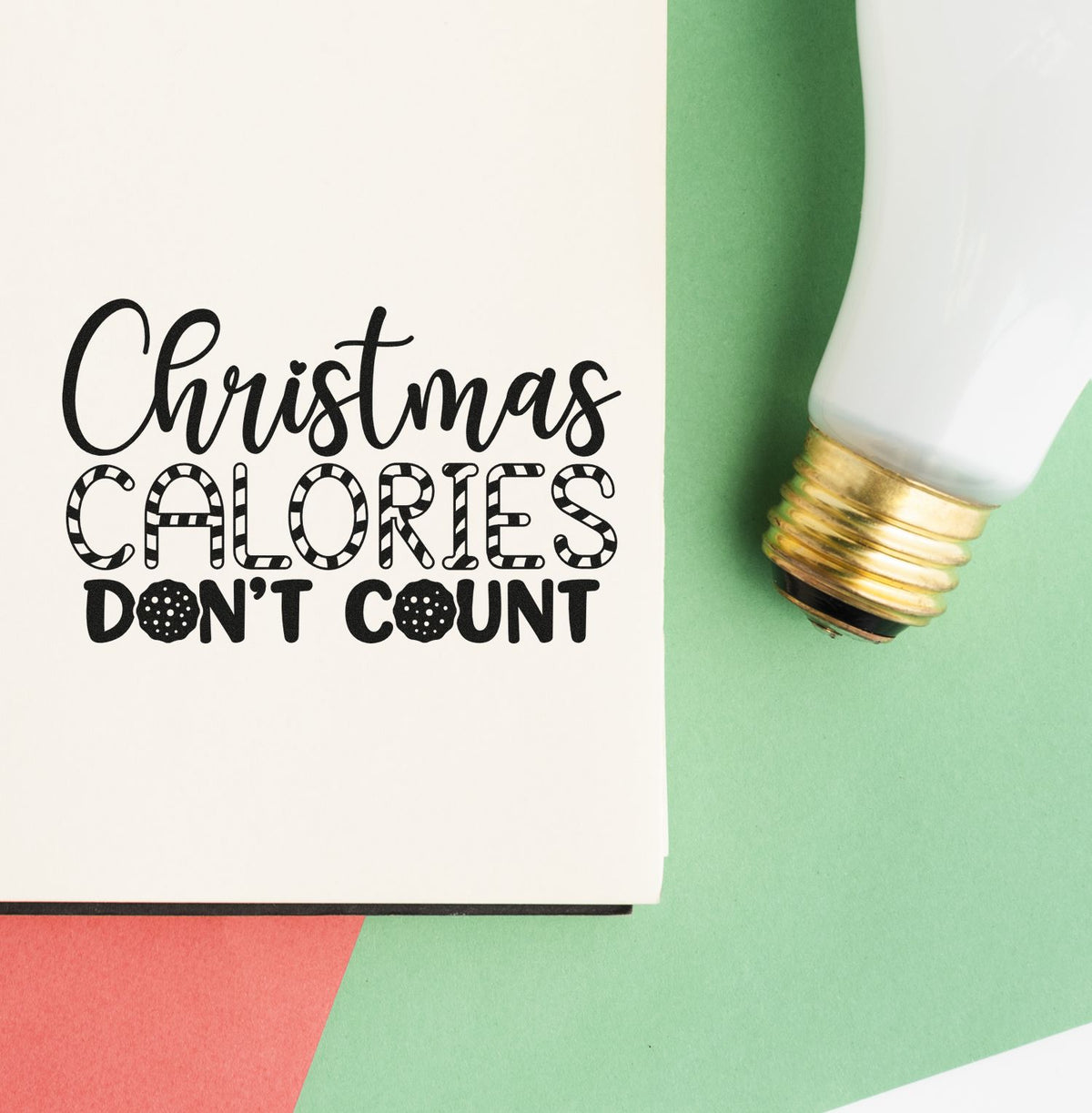 Premium Wooden Christmas Calories Don't Count Script Lettering Stamp - Vintage Pro imprint stamped in black ink. "Christmas Calories Don't Count" combines script, patterned capitals, and bold lettering.