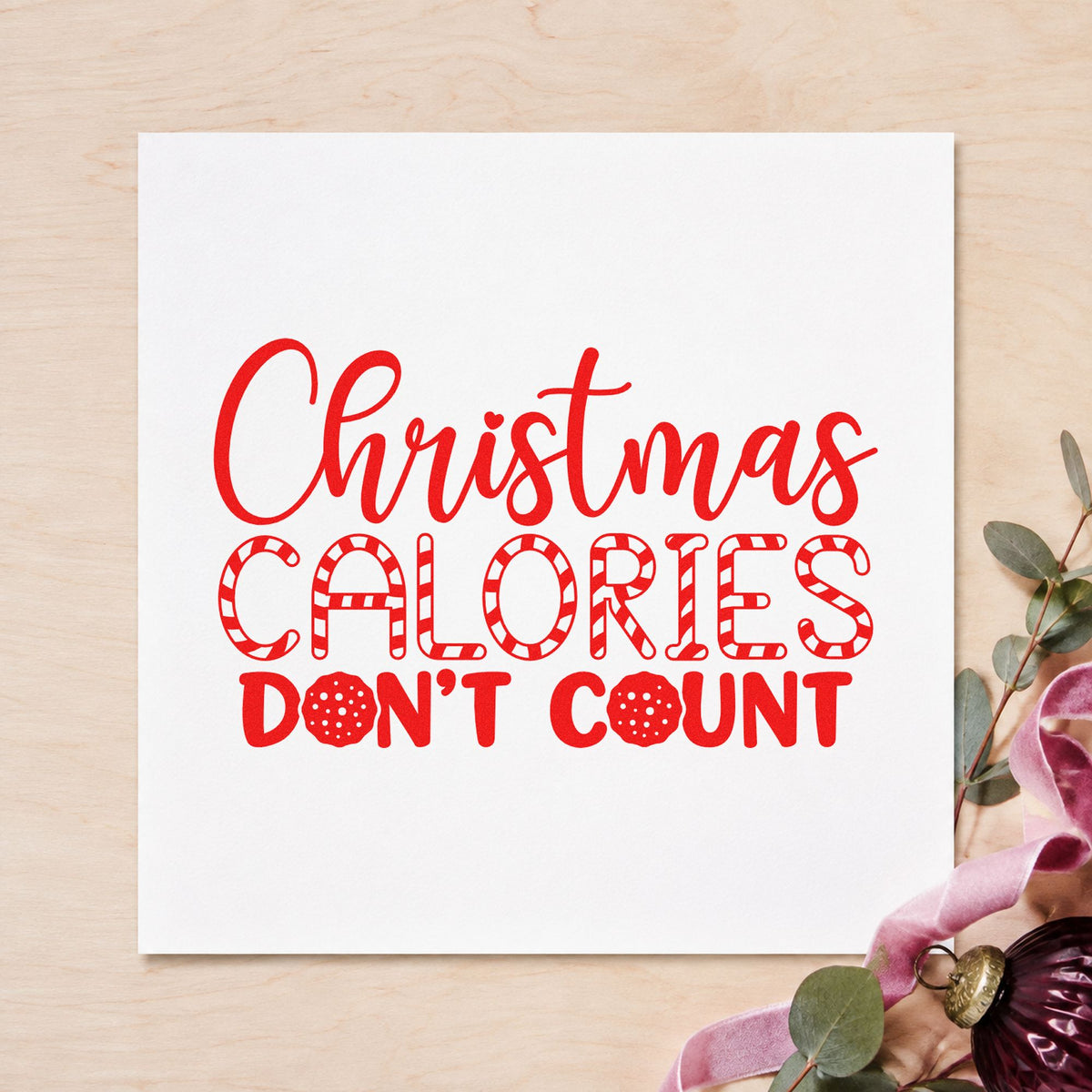 Christmas Calories Don't Count craft stamp in red ink on cardstock, an easy option for gym towel printing.
