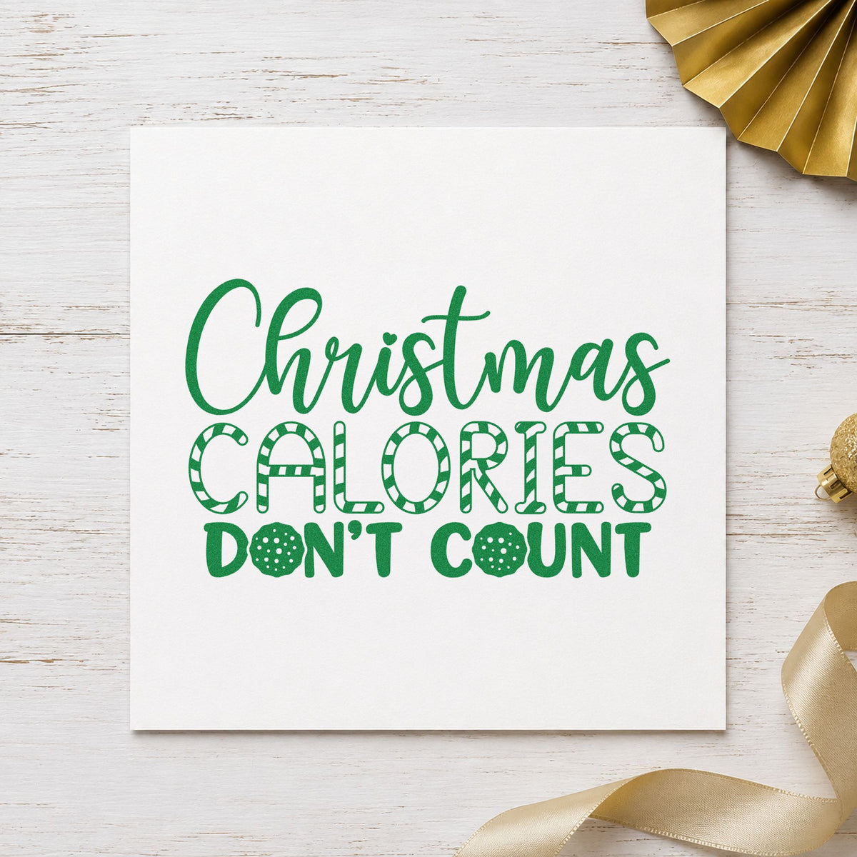 Christmas Calories Don't Count craft stamp imprinted in green ink on paper, a design suited to framed home gym.