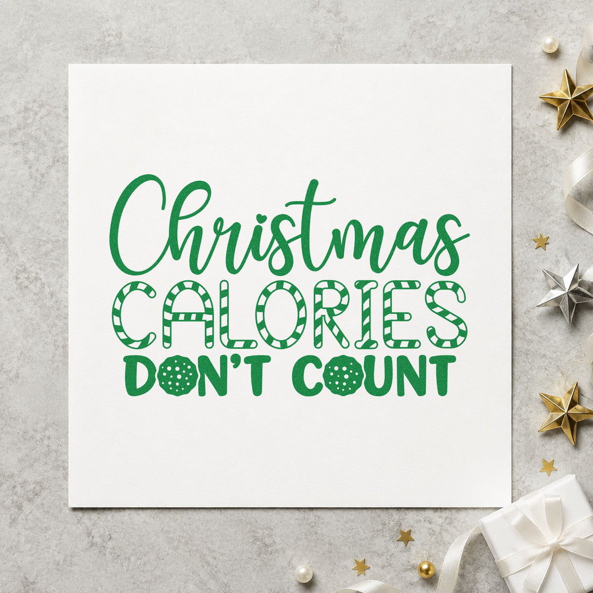 Christmas Calories Don't Count craft stamp imprint in green ink on a handmade project, one idea being challenge board cards.