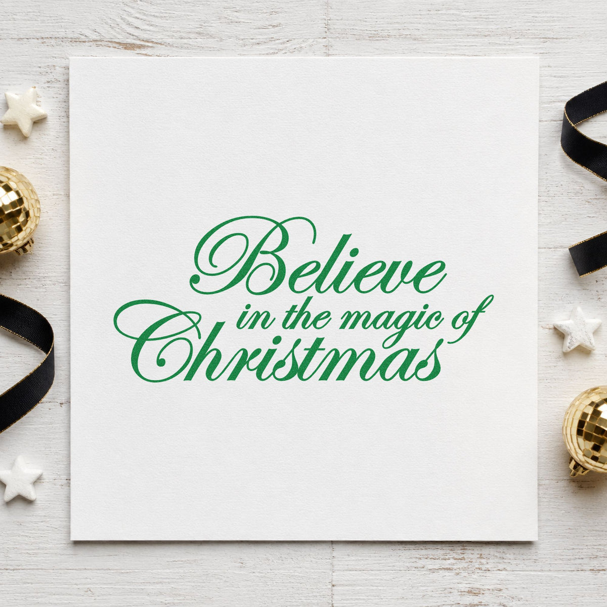 Believe Magic Of Christmas Script craft stamp imprint in green ink on a handmade project, one idea being satin ribbon tags.