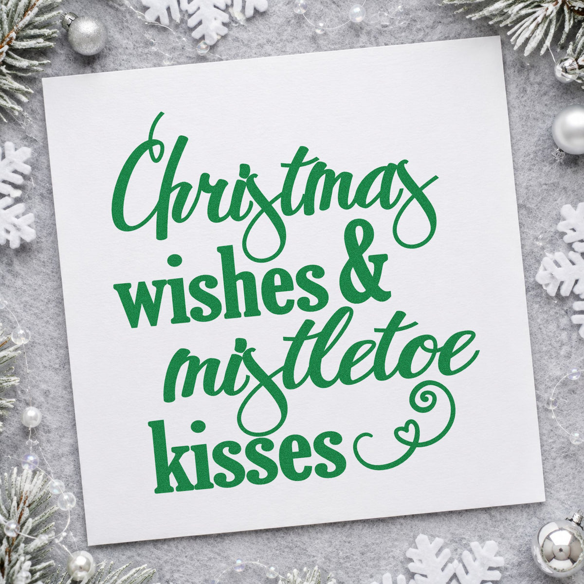 Christmas Wishes Mistletoe Kisses craft stamp imprinted in green ink on paper, a design suited to framed bedside pair.