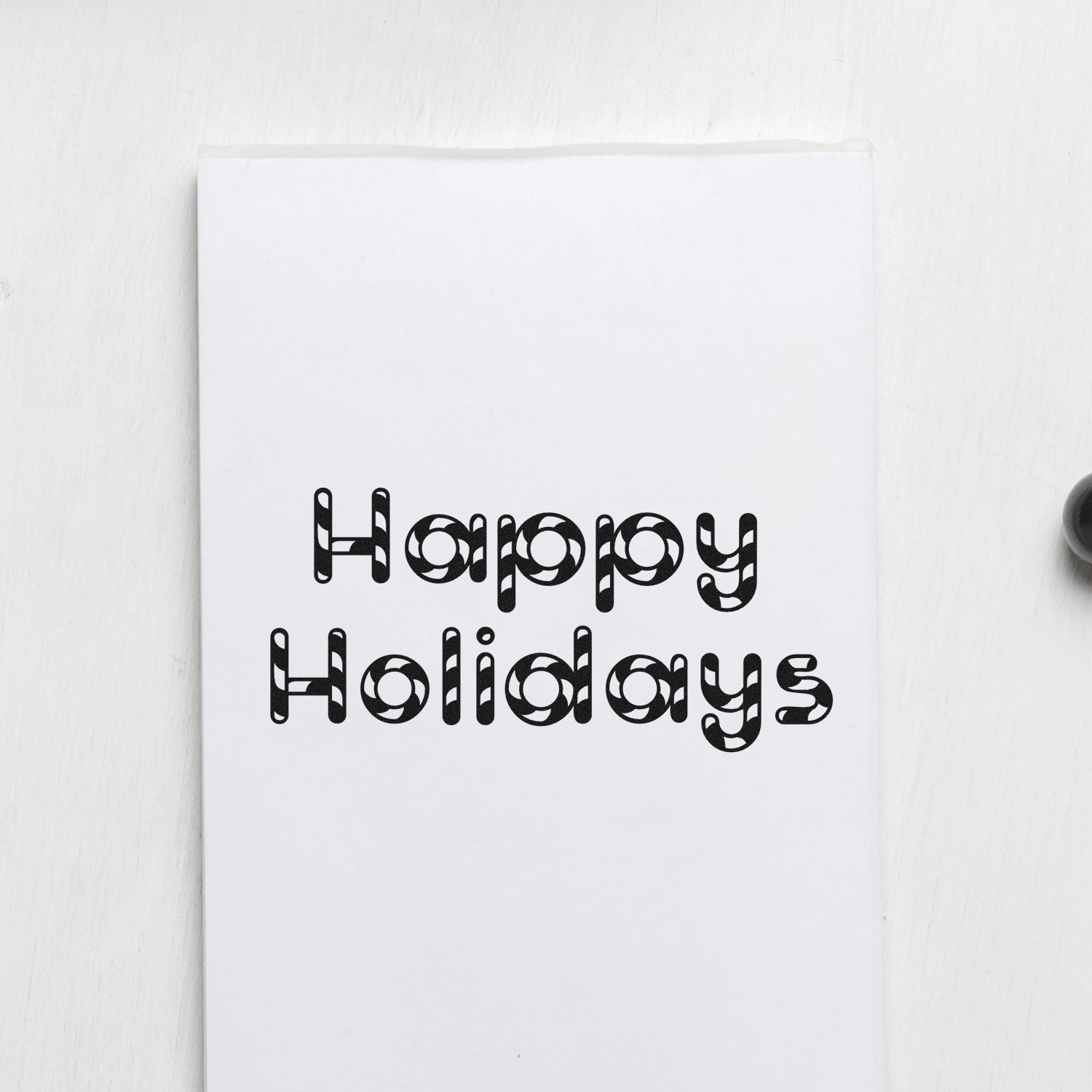 Happy Holidays rubber stamp design on white card, perfect for handmade holiday cards, seasonal crafts, and custom stamp projects.