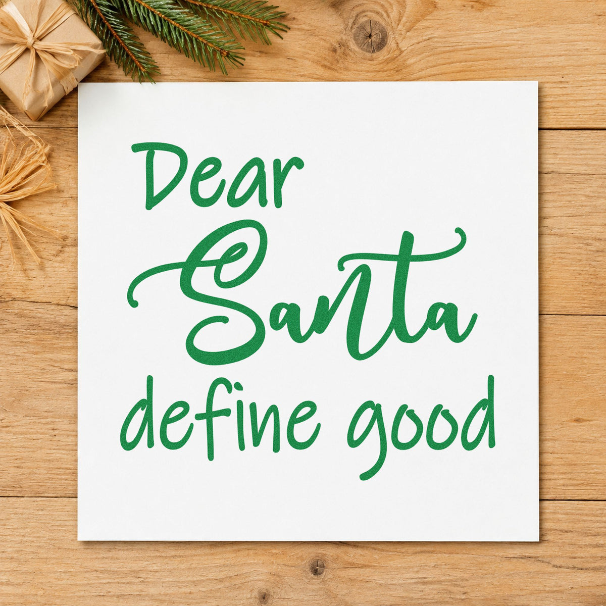 Dear Santa Define Good Script craft stamp imprinted in green ink on paper, a design suited to framed cubicle panel.