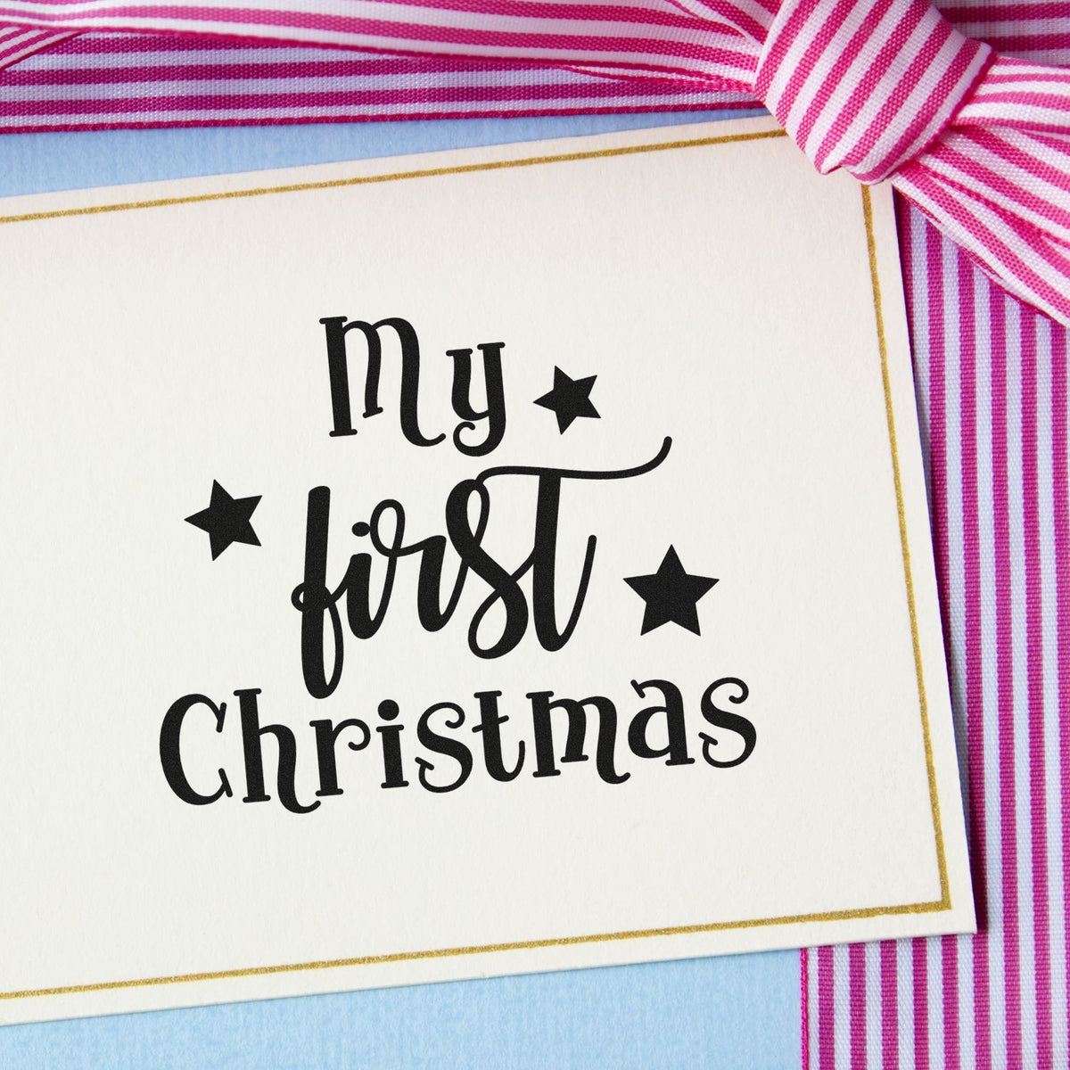 Premium Wooden My First Christmas Stamp - Vintage Pro imprint stamped in black ink. "My First Christmas" mixes serif type and script with three solid stars.