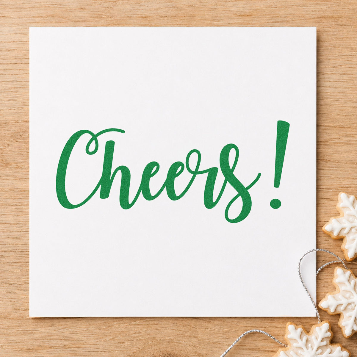 Cheers Flowing Script craft stamp imprinted in green ink on paper, a design suited to framed liquor shelf.