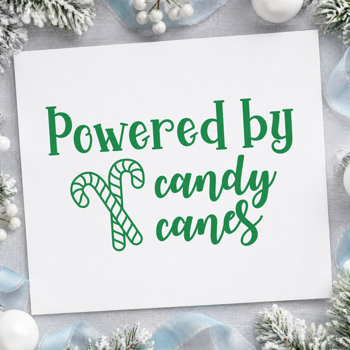 Powered By Candy Canes craft stamp imprint in green ink on a handmade project, one idea being peppermint bark tags.