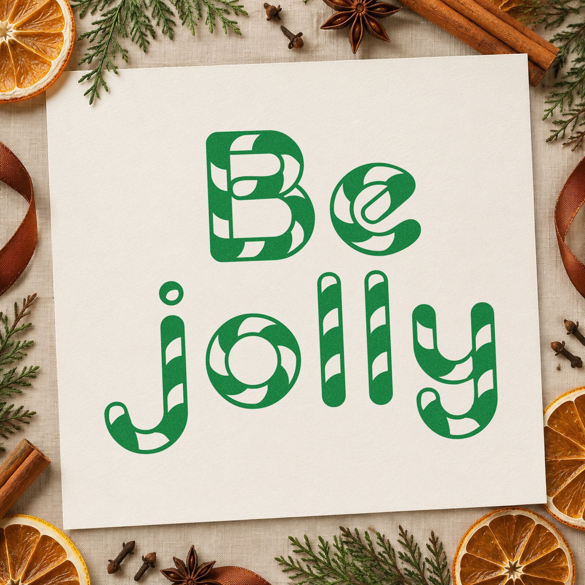 Be Jolly Patterned Letters craft stamp imprinted in green ink on paper, a design suited to framed counter back.
