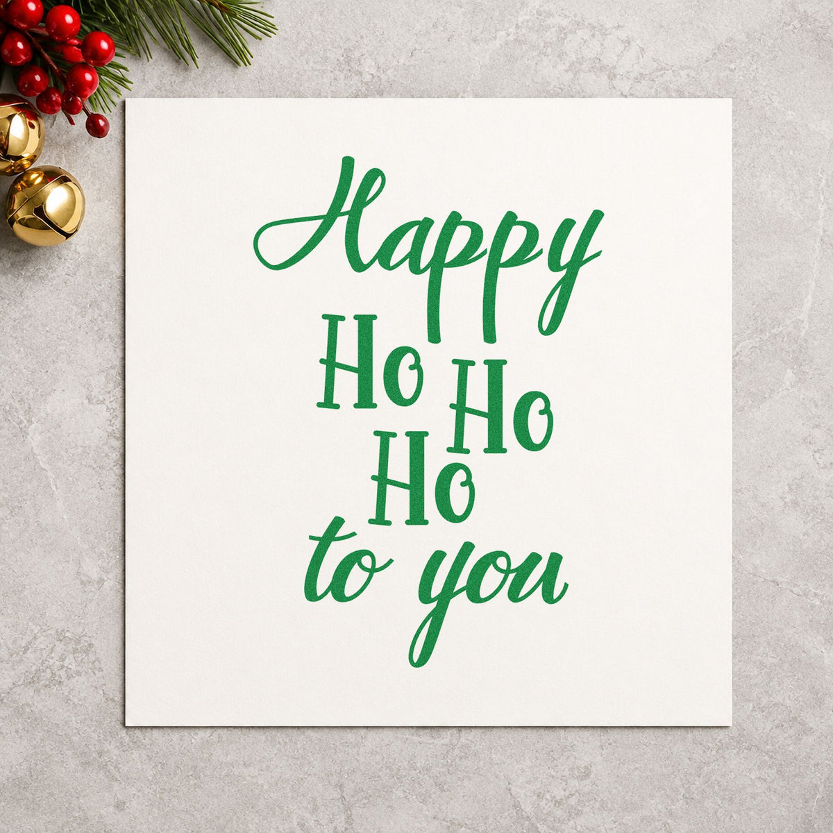 Happy Ho Ho Ho To You craft stamp imprint in green ink on a handmade project, one idea being vertical gift tags.