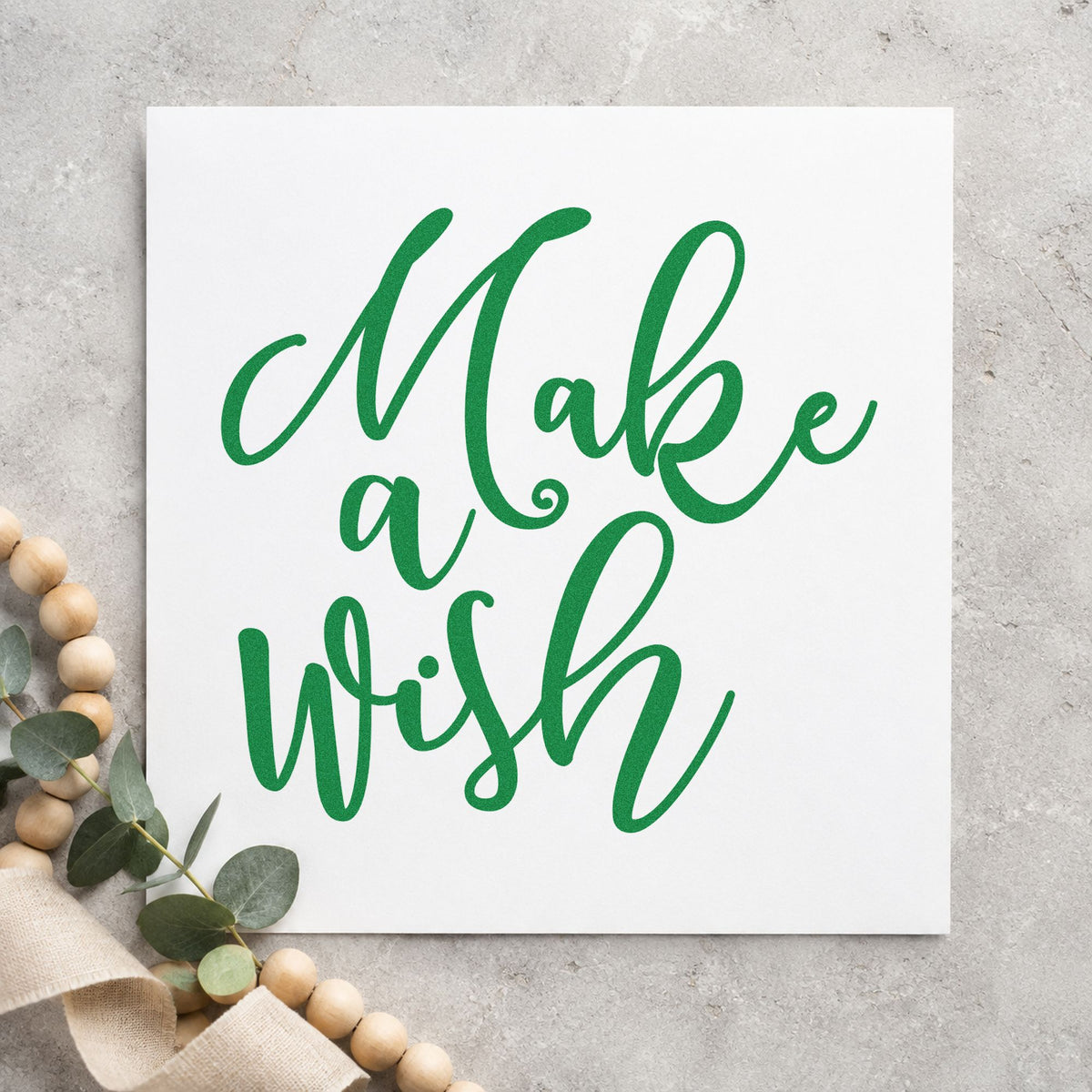 Make A Wish Script craft stamp imprinted in green ink on paper, a design suited to framed dessert table.