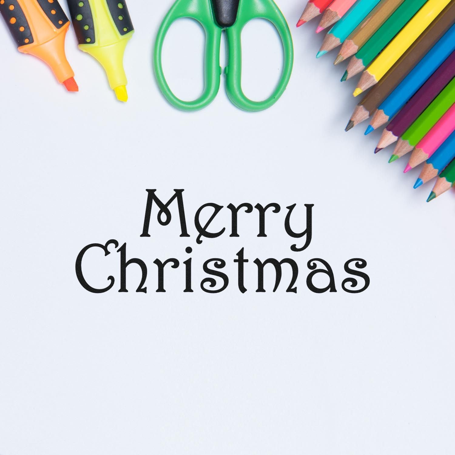 Merry Christmas holiday rubber stamp design with colored pencils and scissors for festive card making and crafts