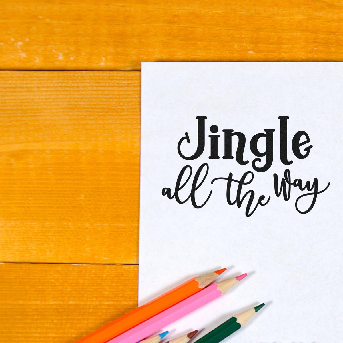 Premium Wooden Jingle All The Way Script Lettering Stamp - Vintage Pro imprint stamped in black ink. Decorative serif "Jingle" sits above flowing script "All the Way."