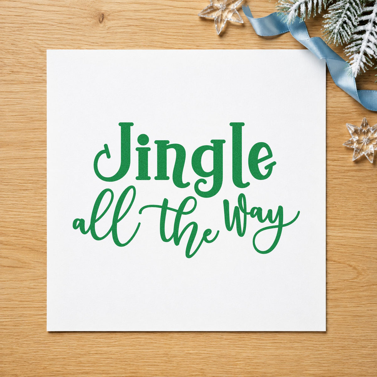 Jingle All The Way Script craft stamp imprint in green ink on a handmade project, one idea being bell garland tags.