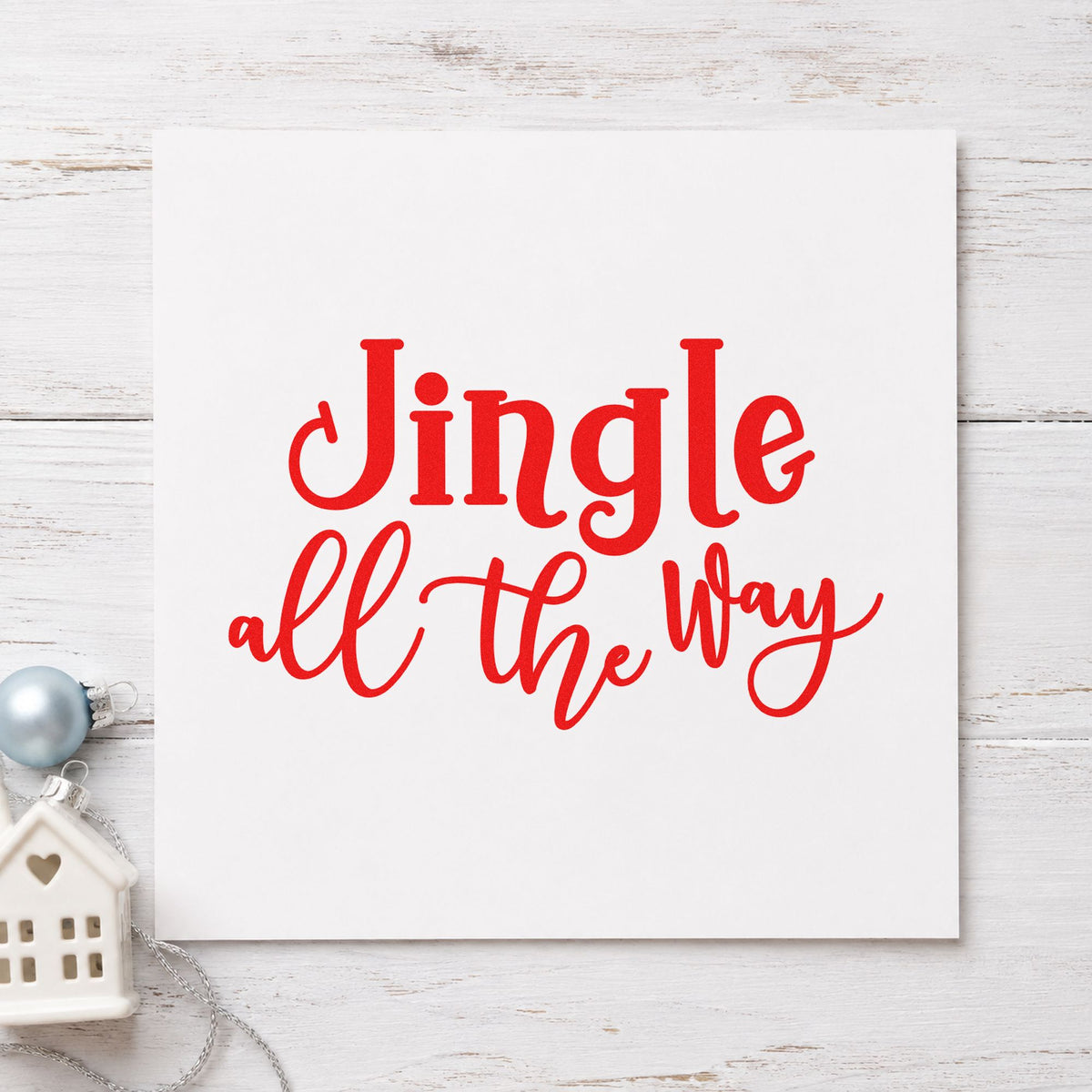 Jingle All The Way Script craft stamp in red ink on cardstock, an easy option for felt strip printing.