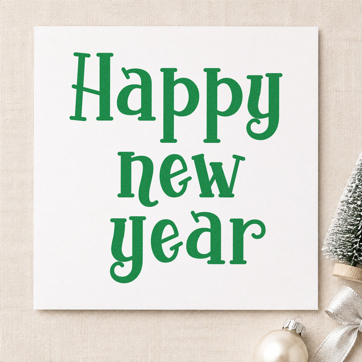 Happy New Year Serif craft stamp imprint in green ink on a handmade project, one idea being planner gift tags.