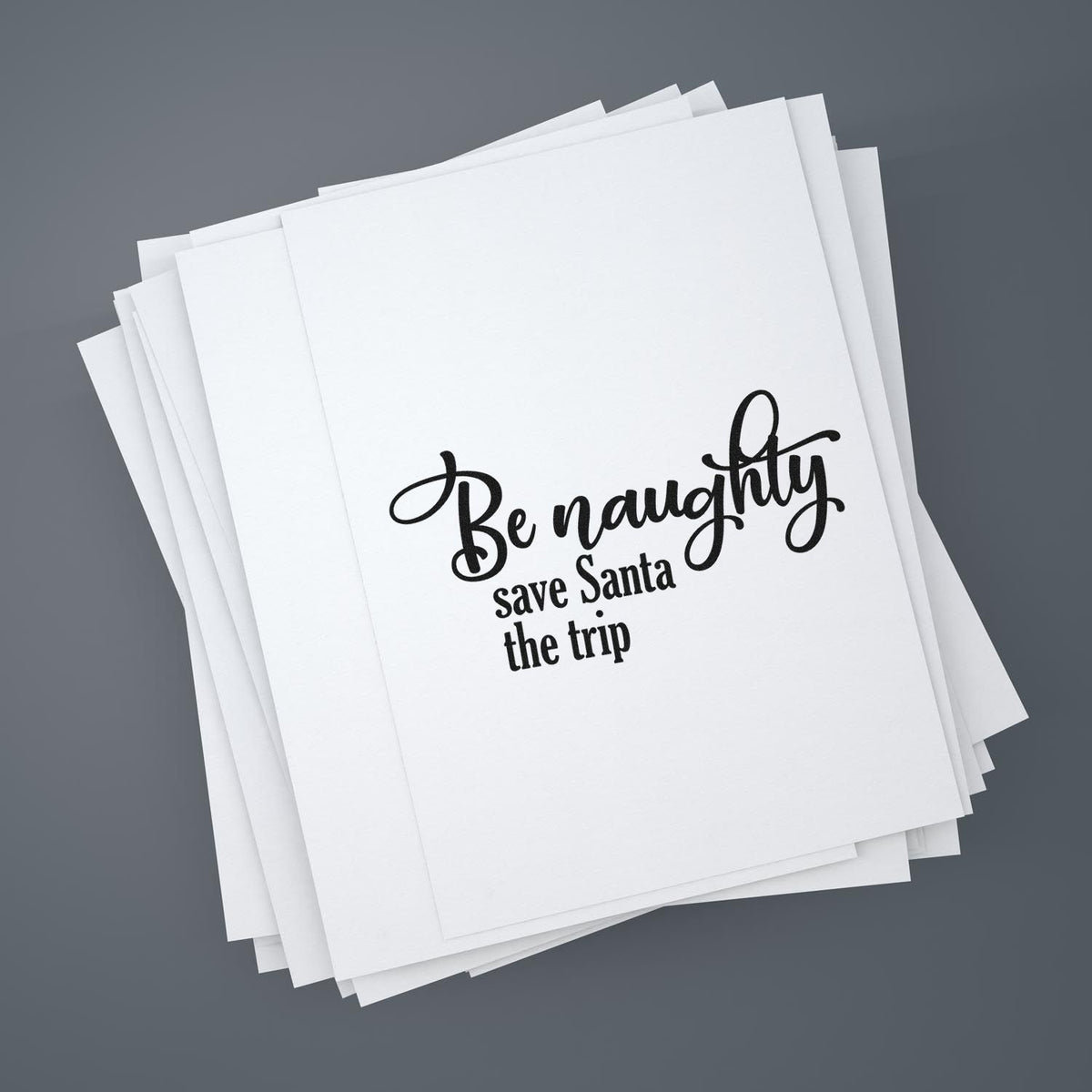 Be Naughty Save Santa Trip Script Lettering Stamp - Premium Vintage Pro Wooden imprint stamped in black ink. Script "Be Naughty" sits above smaller "Save Santa the Trip."