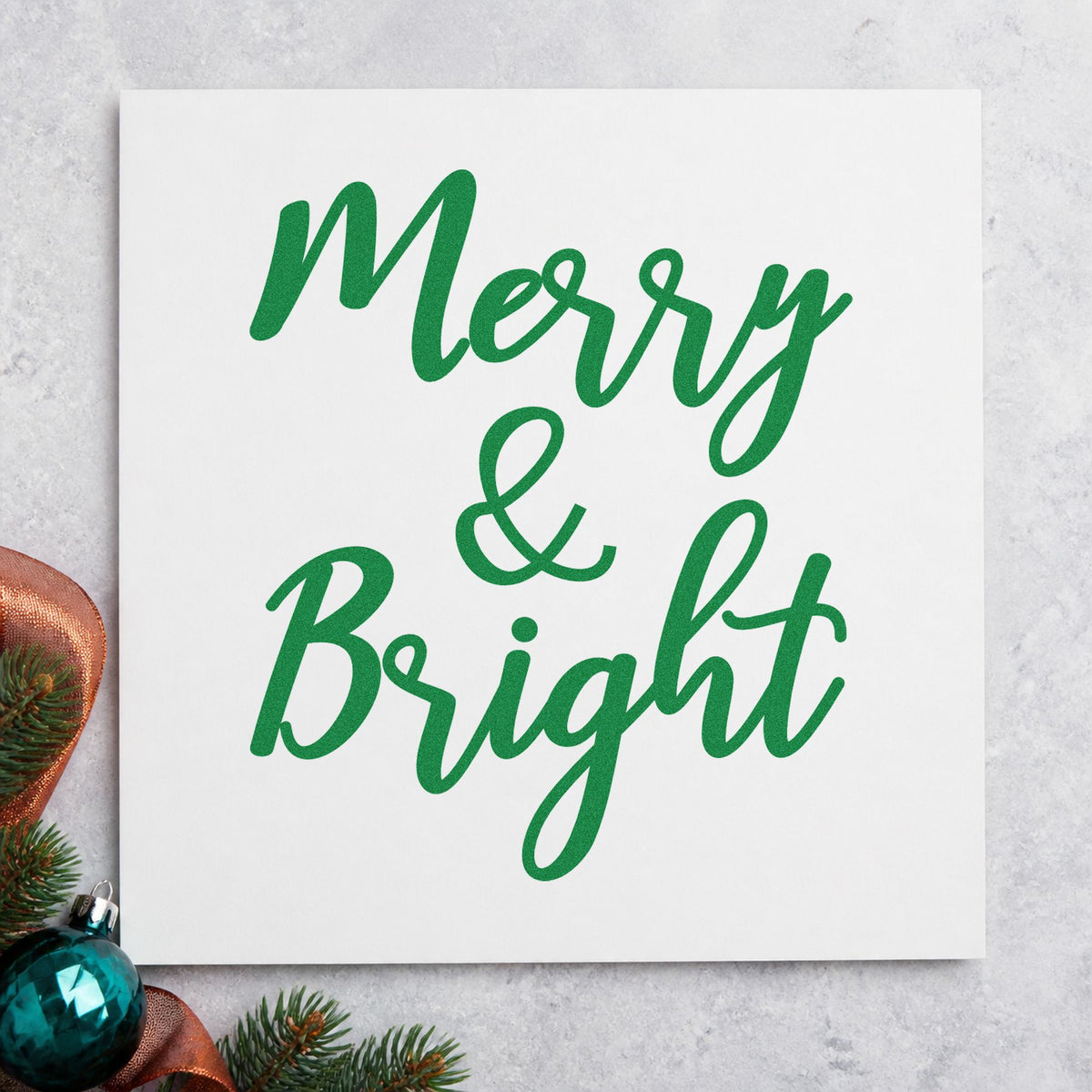 Merry And Bright Brush Script craft stamp imprint in green ink on a handmade project, one idea being event direction signs.