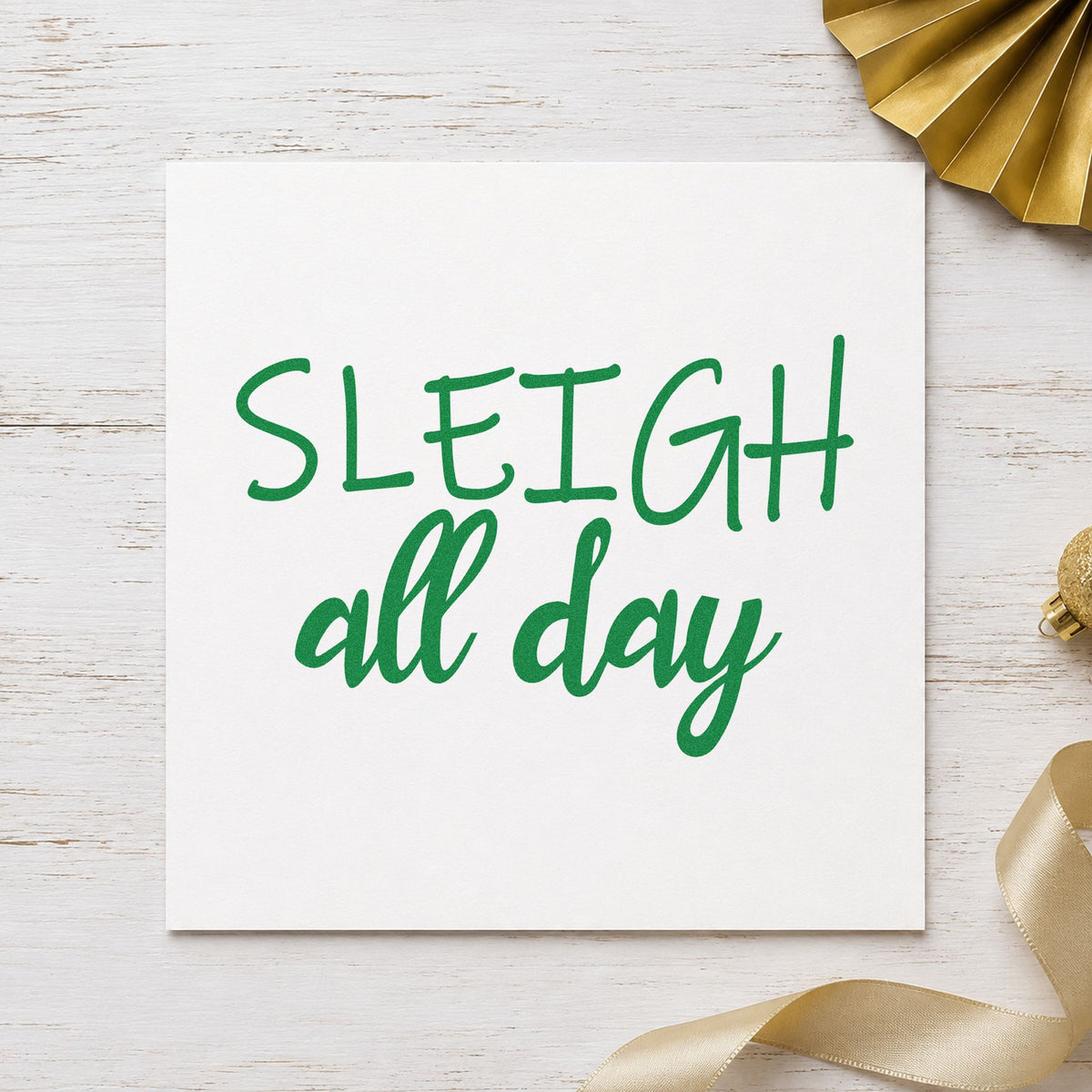 Sleigh All Day craft stamp imprint in green ink on a handmade project, one idea being boutique bag tags.