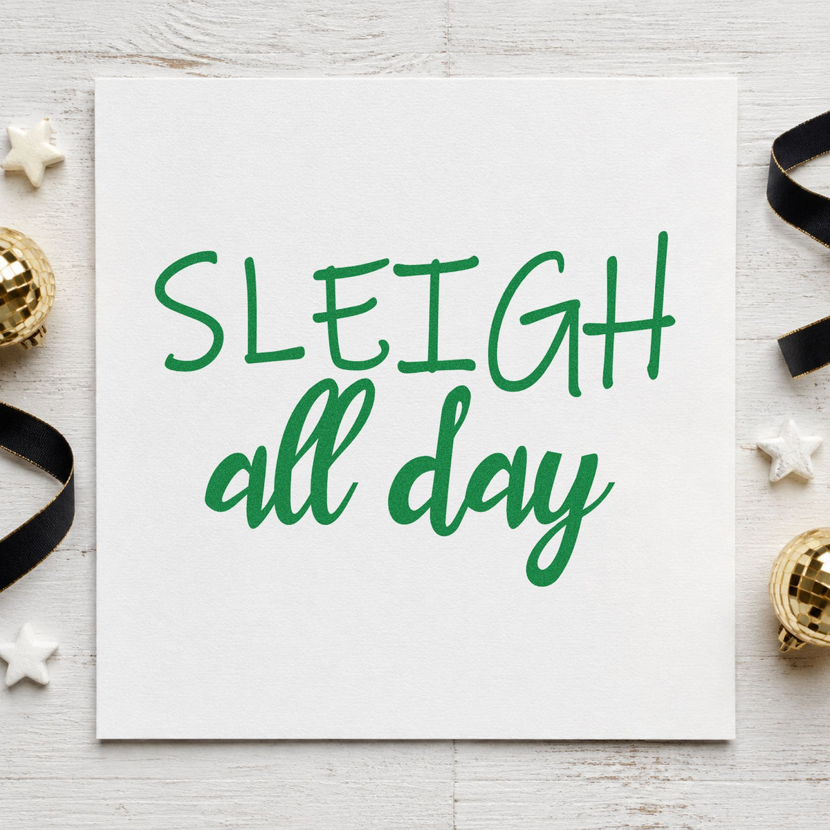 Sleigh All Day craft stamp imprint in green ink on a handmade project, one idea being pop up shop signs.