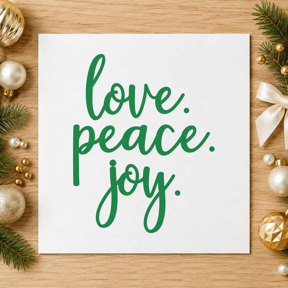 Love Peace Joy Script craft stamp imprint in green ink on a handmade project, one idea being matched set tags.