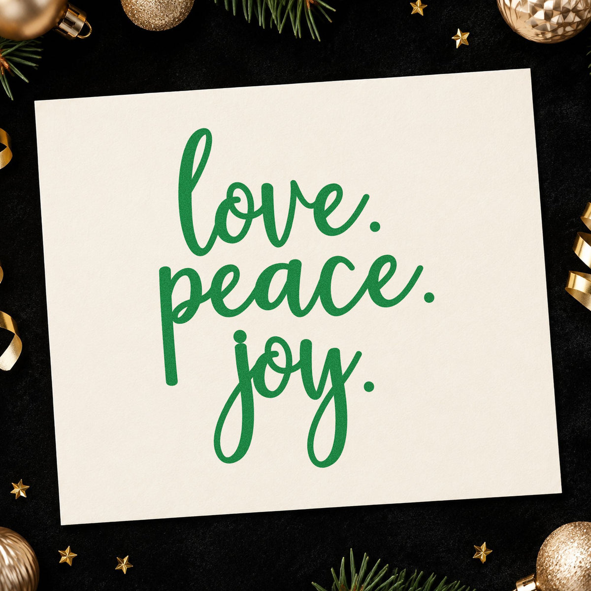 Love Peace Joy Script craft stamp imprint in green ink on a handmade project, one idea being table trio placards.
