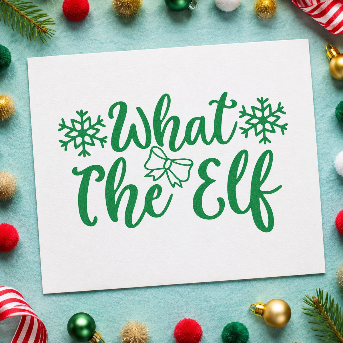What The Elf Snowflakes craft stamp imprint in green ink on a handmade project, one idea being game night placards.