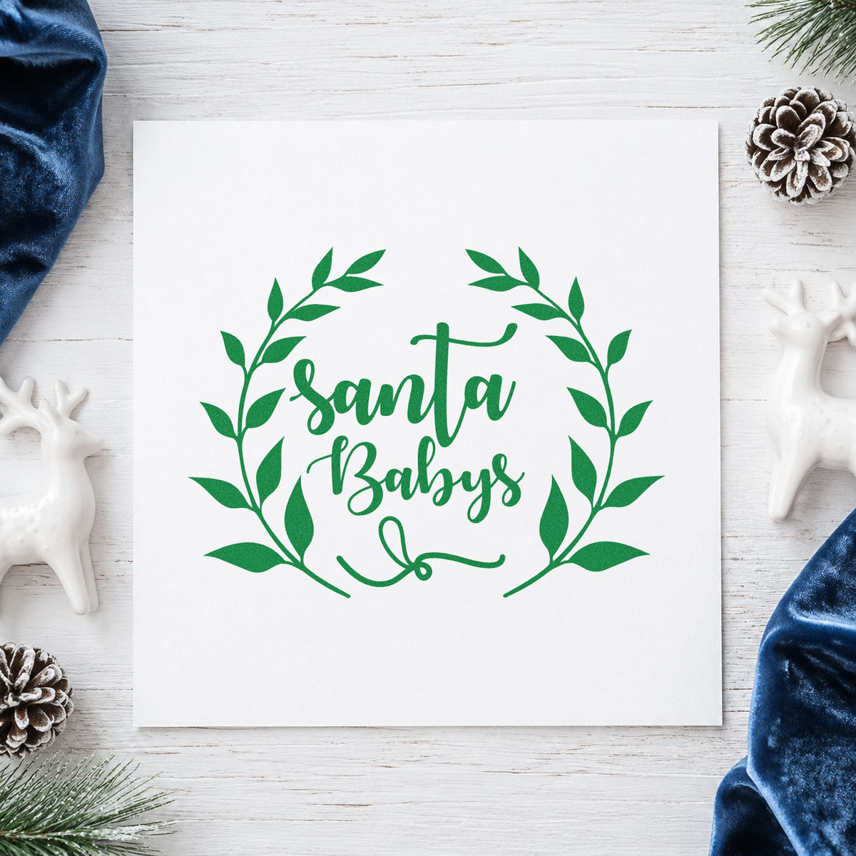 Santa Babys Leaf Wreath craft stamp imprinted in green ink on paper, a design suited to framed dressing room.