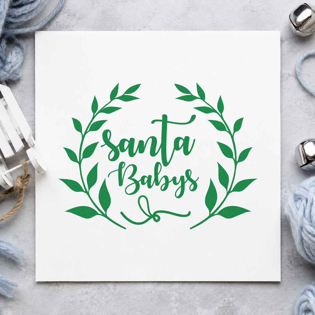 Santa Babys Leaf Wreath craft stamp imprint in green ink on a handmade project, one idea being lounge night menus.