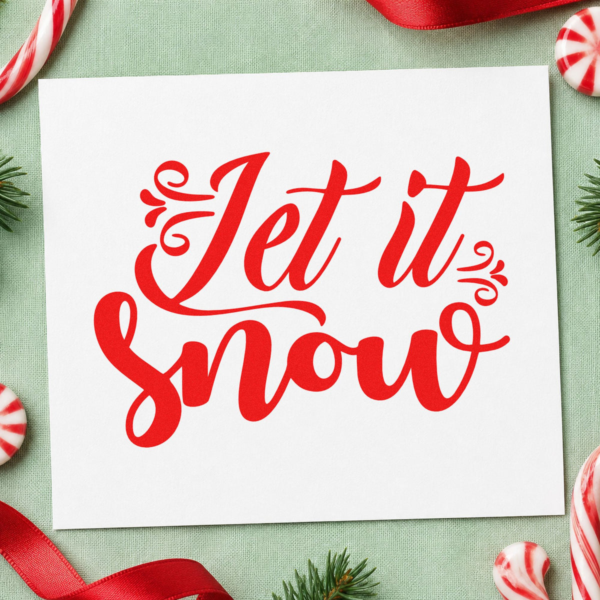 Let It Snow Ornate Script craft stamp in red ink on cardstock, an easy option for snow pants patch ink.