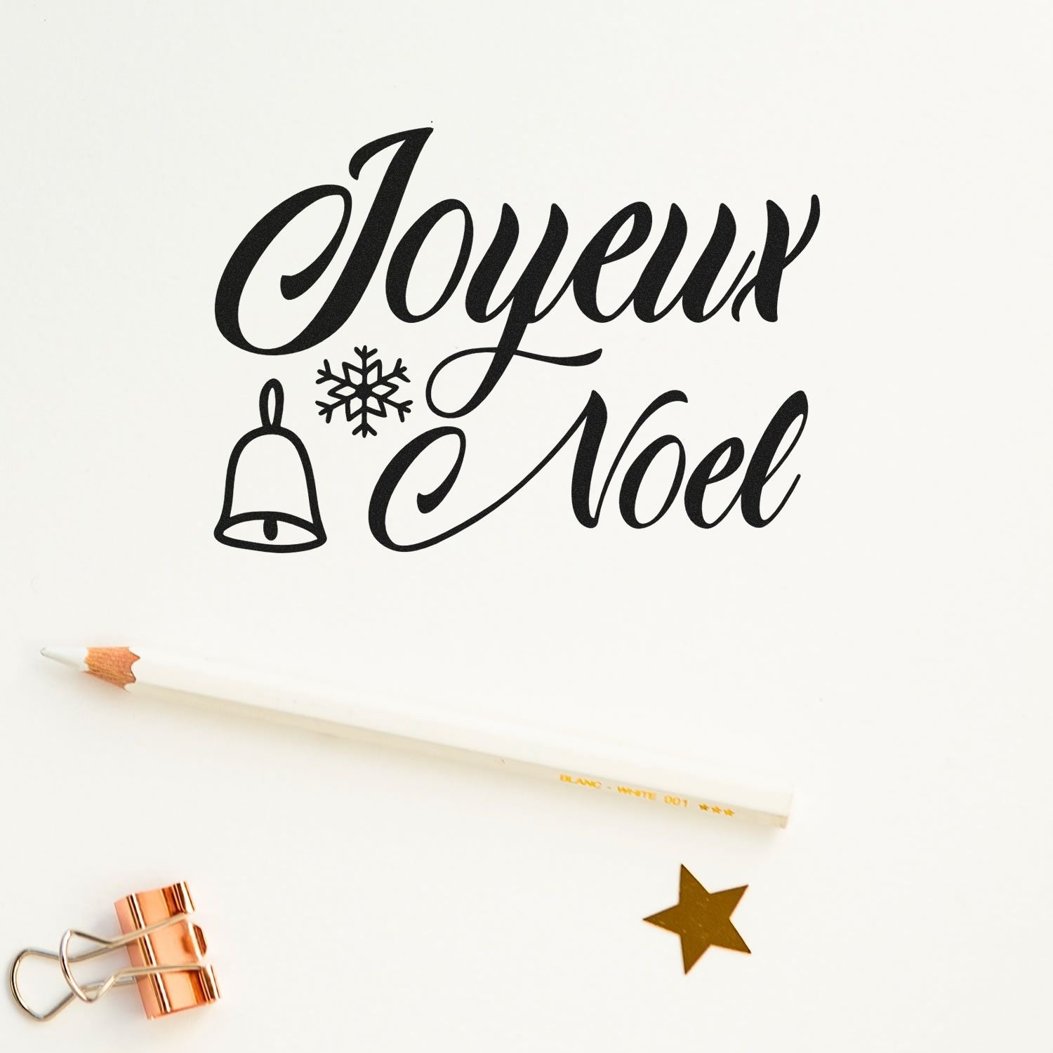 Joyeux Nol holiday rubber stamp design with bell and snowflake, perfect for Christmas cards and festive crafts.