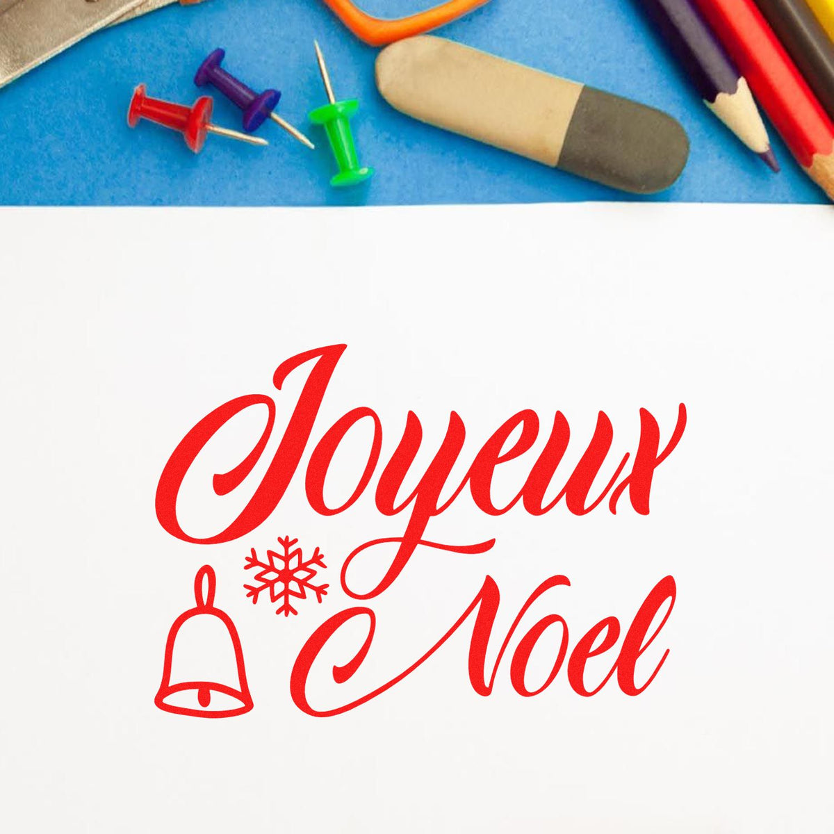 Joyeux Noel Bell Snowflake rubber stamp shown in red ink, stamped for projects such as travel album page.